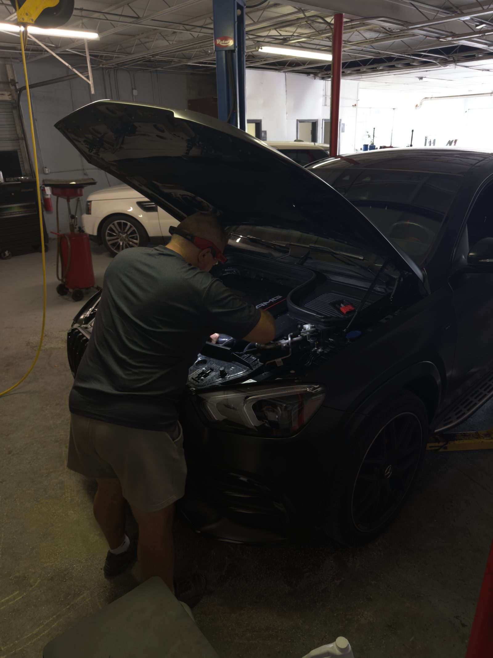 Robert working under the hood of a car at R&I Auto Repair